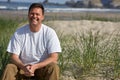 Smiling Man sitting on Beach Royalty Free Stock Photo