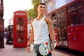 Smiling man with skateboard on london city street Royalty Free Stock Photo