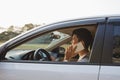 Smiling Man Speak on Smart Phone in White Car. The businessman successful driving his car and speaking on the cellphone Royalty Free Stock Photo