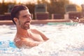 Smiling Man Splashing Water On Summer Vacation In Outdoor Swimming Pool Royalty Free Stock Photo