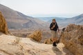 Smiling man standing in stone desert. Royalty Free Stock Photo