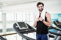 Smiling man standing on treadmill Royalty Free Stock Photo