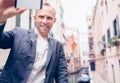 Smiling man take a selfie tourist photo on the Venice chanel background Royalty Free Stock Photo