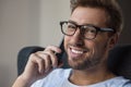 Young smiling man glasses talking on smartphone and looking Royalty Free Stock Photo