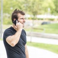 Smiling man talking by telephone.