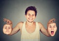 Smiling man with two different emotion masks