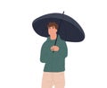 Smiling man with an umbrella. A happy man wearing a raincoat walks down the street on a rainy day. The autumn season is
