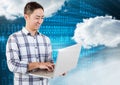 Smiling man using laptop with clouds and binary codes in background Royalty Free Stock Photo