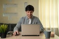 Smiling man using laptop studying working online at home Royalty Free Stock Photo