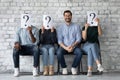 Smiling man wait for interview among unknown applicants