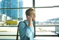 Smiling man walking and talking on mobile phone at the airport Royalty Free Stock Photo