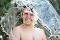 Smiling man in water splash Royalty Free Stock Photo