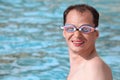 Smiling man in watersport goggles swimming in pool