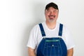 Smiling man wearing dungarees with cap Royalty Free Stock Photo