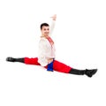 Smiling man wearing a folk ukrainian costume makes splits Royalty Free Stock Photo
