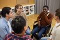 Smiling Man in Wheelchair Sharing with Support Group