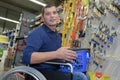 Smiling man in wheelchaire shopping in household store Royalty Free Stock Photo