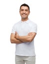 Smiling man in white t-shirt with crossed arms Royalty Free Stock Photo