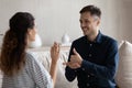 Smiling man and woman with deafness using signs for communication