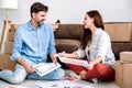 Smiling man and woman discuss interior design improvement in new flat