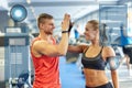 Smiling man and woman doing high five in gym Royalty Free Stock Photo