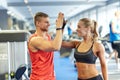 Smiling man and woman doing high five in gym Royalty Free Stock Photo