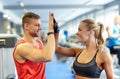 Smiling man and woman doing high five in gym Royalty Free Stock Photo