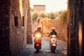 Smiling man and woman riding motor scooter on city.Bikers on the road Royalty Free Stock Photo