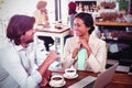 Smiling man and woman using a laptop while having cup of coffee Royalty Free Stock Photo