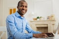 Smiling man working from home at weekend