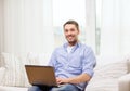 Smiling man working with laptop at home Royalty Free Stock Photo