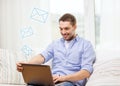 Smiling man working with laptop at home Royalty Free Stock Photo