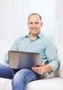 Smiling man working with laptop at home Royalty Free Stock Photo