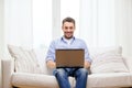 Smiling man working with laptop at home Royalty Free Stock Photo