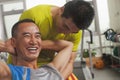 Smiling man working out with his trainer, doing sit ups Royalty Free Stock Photo