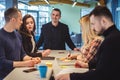 Smiling manager looking at his colleague at office meeting