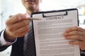 Smiling manager shows contract on clipboard in office Royalty Free Stock Photo