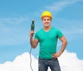 Smiling manual worker in helmet with drill machine Royalty Free Stock Photo