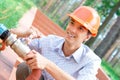 Smiling manual worker repairing pipe