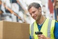 Smiling manual worker scanning package Royalty Free Stock Photo