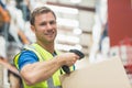 Smiling manual worker scanning package Royalty Free Stock Photo