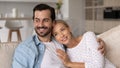 Smiling married couple relaxing and hugging on couch at home Royalty Free Stock Photo