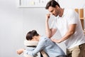 Masseur massaging businesswoman back with elbow Royalty Free Stock Photo