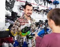 Master fixing roller-skates for boy customer in sports store
