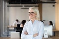 Smiling mature businesswoman dreaming in office, business vision concept Royalty Free Stock Photo