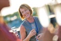 Smiling mature businesswoman talking with colleagues during success party on rooftop Royalty Free Stock Photo