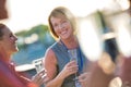 Smiling mature businesswoman talking with colleagues during success party on rooftop Royalty Free Stock Photo