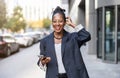 Smiling mature businesswoman using mobile phone in urban setting Royalty Free Stock Photo