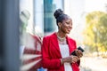 Smiling mature businesswoman using mobile phone in urban setting Royalty Free Stock Photo