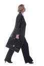 Smiling mature businesswoman walking to side with briefcase Royalty Free Stock Photo